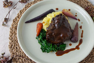 Braised Ox Cheek with wilted spinach, buttery mash potato and rainbow chantenay carrots, drizzled with a rich jus