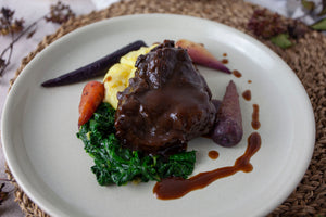 Braised Ox Cheek with wilted spinach, buttery mash potato and rainbow chantenay carrots, drizzled with a rich jus