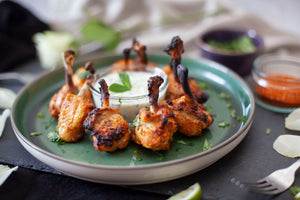 Tandoori Chicken Lollipops served with a cucumber and mint dipping sauce