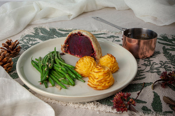 Beetroot wellington served with balsamic sauce, pomme duchesse, and green beans