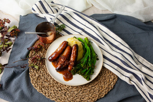 Wild boar sausages, buttery mash potato, tenderstem and red onion and redcurrant gravy