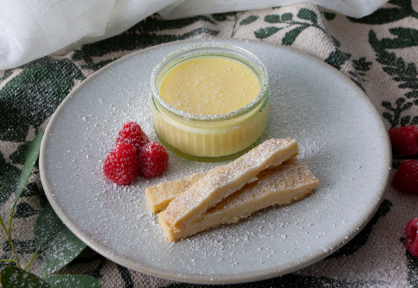 Lemon posset served with homemade shortbread and fresh raspberries