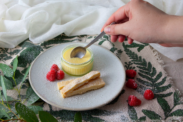 Lemon posset served with homemade shortbread and fresh raspberries