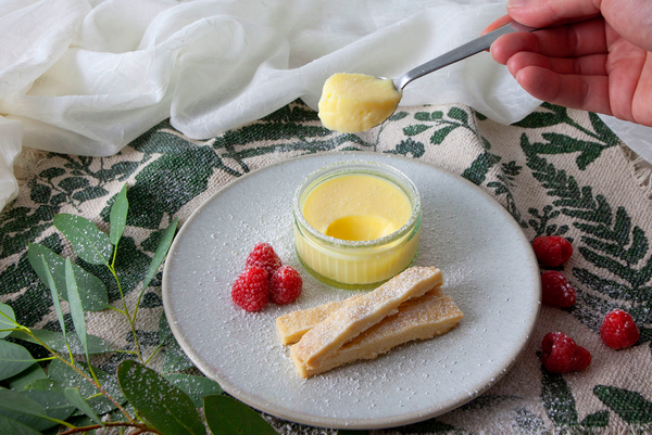 Lemon posset served with homemade shortbread and fresh raspberries