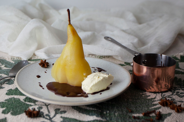 Poached pear with chocolate sauce and chantilly cream
