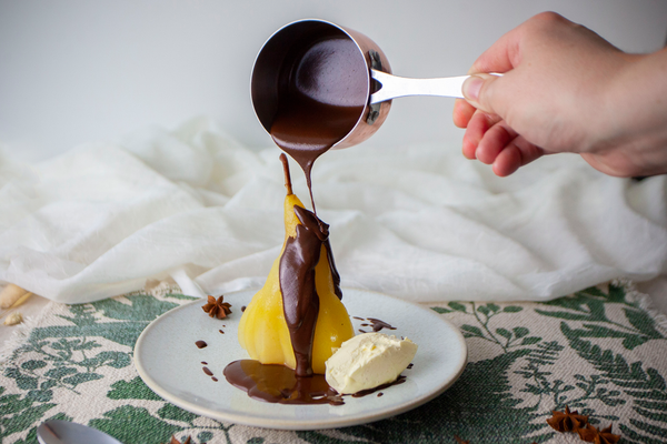 Poached pear with chocolate sauce and chantilly cream