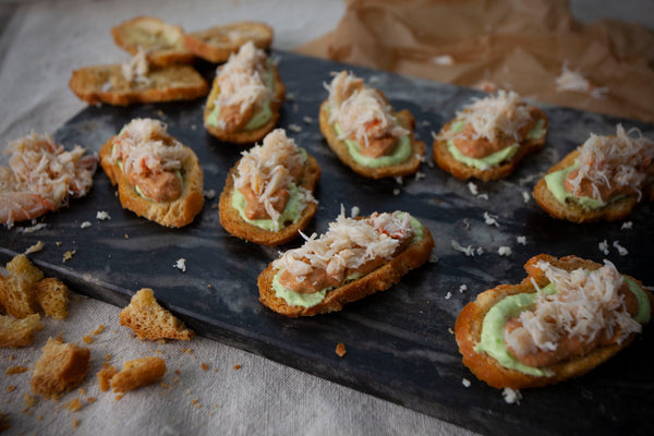 Crab & avocado on melba toast served as canapes