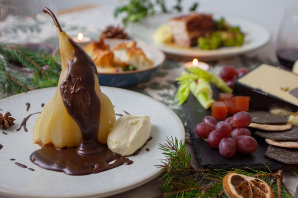 Poached pear with chocolate sauce and chantilly cream