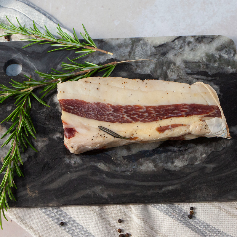 Raw meat with rosemary on a marble slab