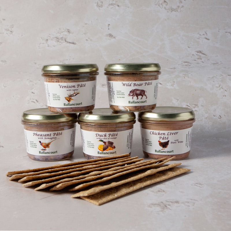 Jars of Ballancourt pâtés arranged with crackers in front, displayed on a neutral background.
