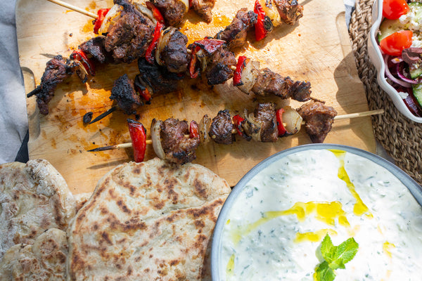 Wild boar kebabs with flatbreads and tzatziki
