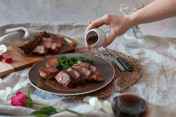 Image of Galician Steak Night Recipe box, pouring the red wine jus over the cooked steak