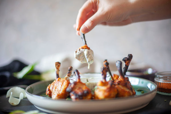 Tandoori Chicken Lollipops served with a cucumber and mint dipping sauce
